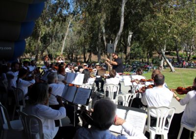 The SoCal Philharmonic performs in a park.