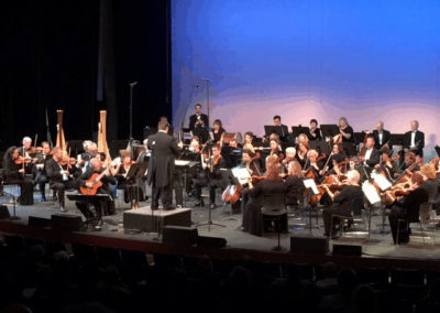 SoCal Philharmonic performs on stage in front of an audience.