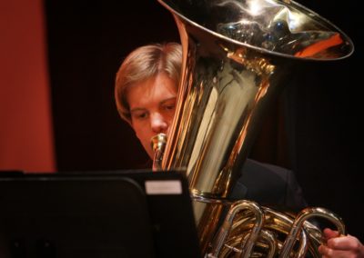 A man playing tuba in a suit for SoCal Philharmonic.